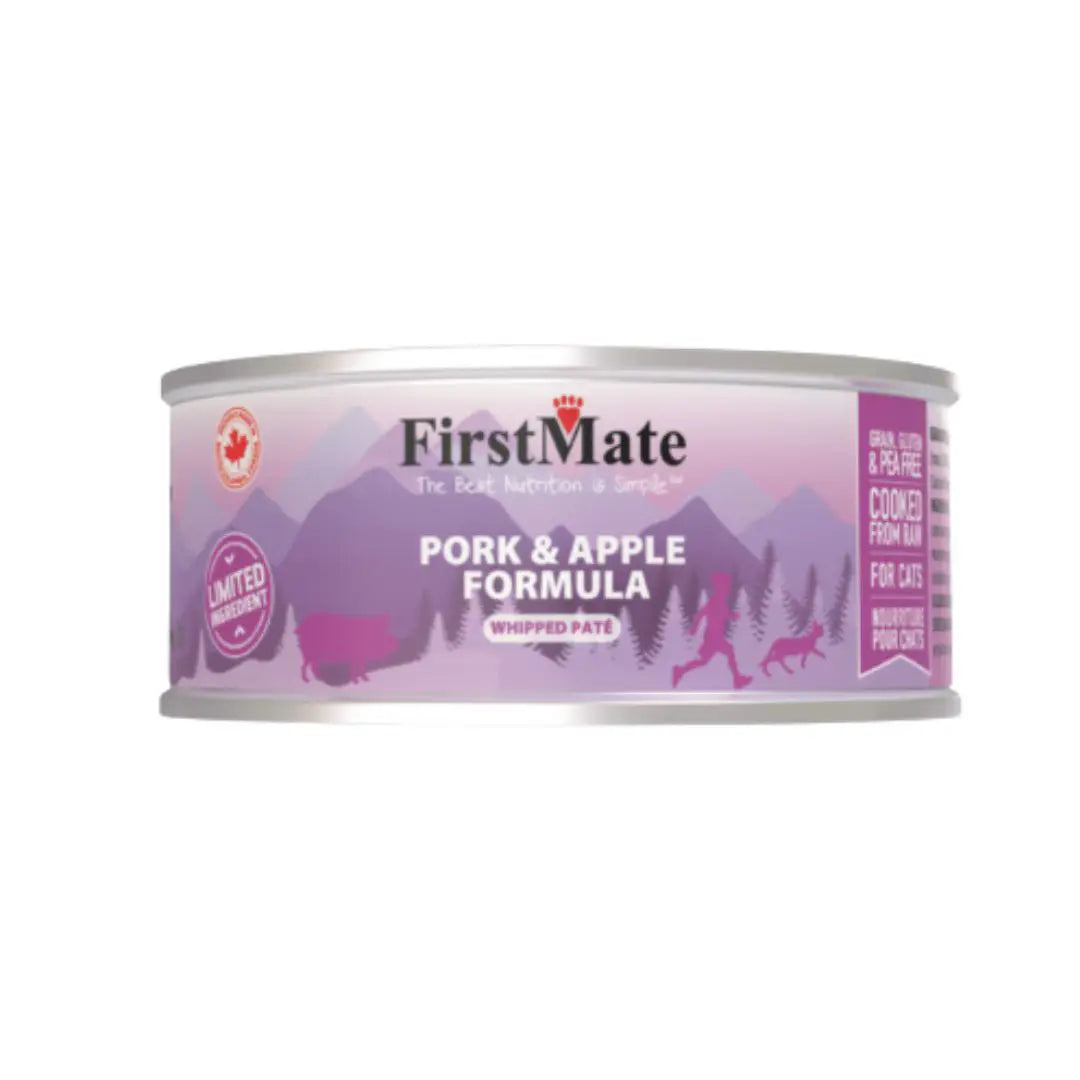 A can of FirstMate Pork & Apple Formula wet cat food, featuring a purple and pink label with silhouettes of mountains, deer, and a wolf, on a plain white background at Harmony Pet Supplies, Scarborough.