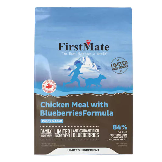 A bag of FirstMate Limited Ingredient Chicken Meal with Blueberries Formula for dogs. The packaging is primarily blue and white, with an image of a dog and blueberries visible.