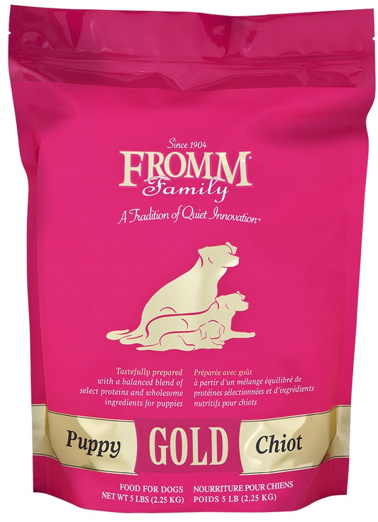 Pink bag of Fromm Family Puppy Gold dog food with branding and product details.