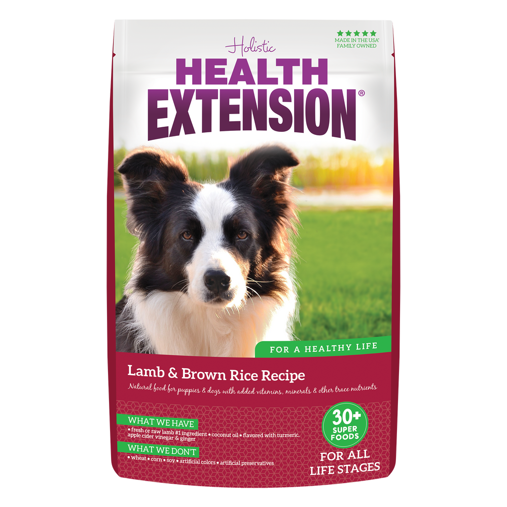 A bag of Health Extension Lamb & Brown Rice Recipe dry dog food featuring a picture of a dog on the front.