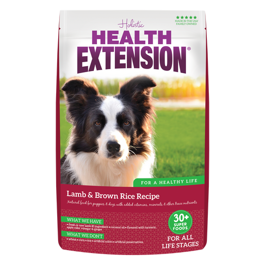 A bag of Health Extension Lamb & Brown Rice Recipe dry dog food featuring a picture of a dog on the front.
