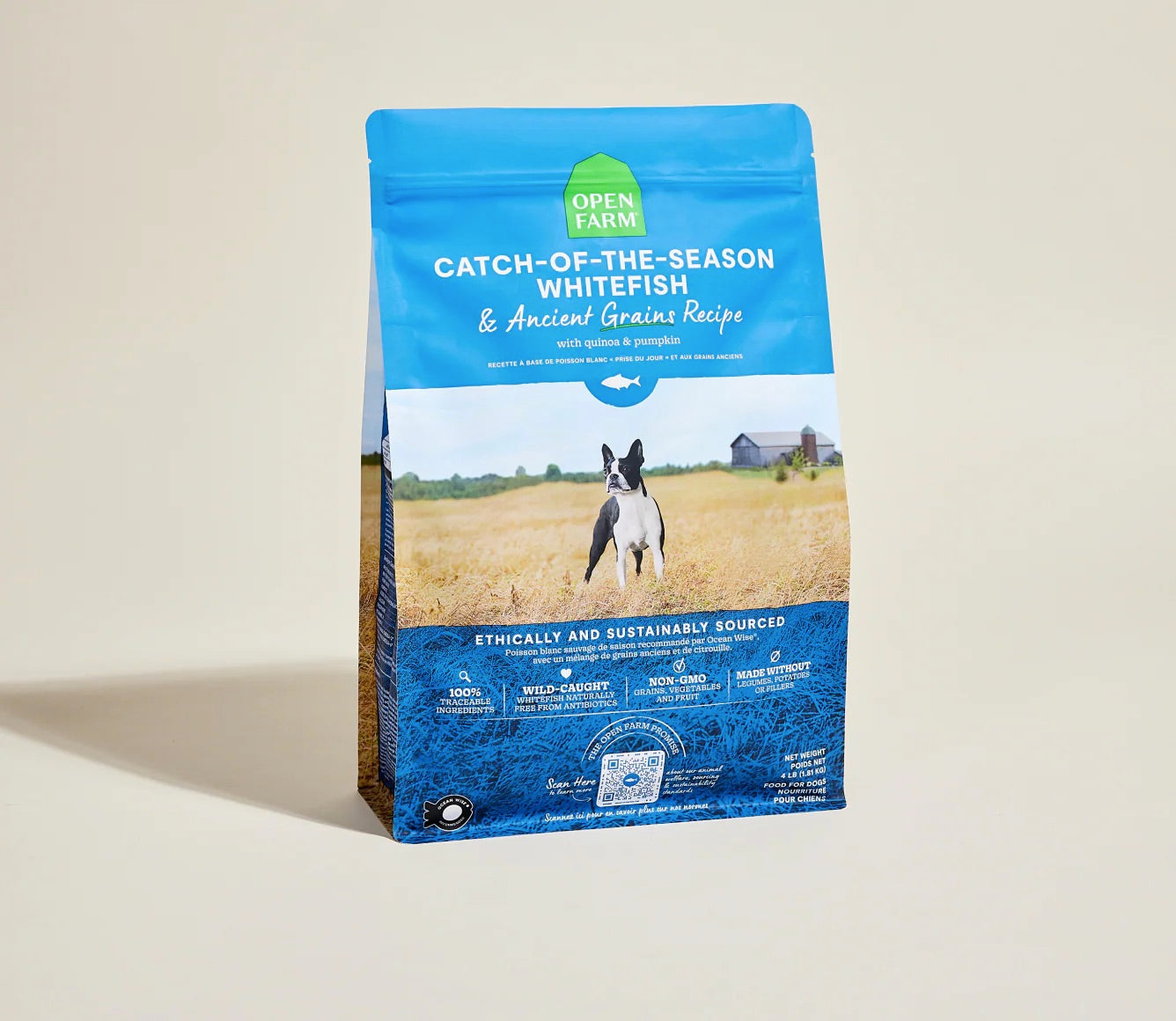Open farm Dog food package with blue label featuring a dog and scenic background on a beige background, front.