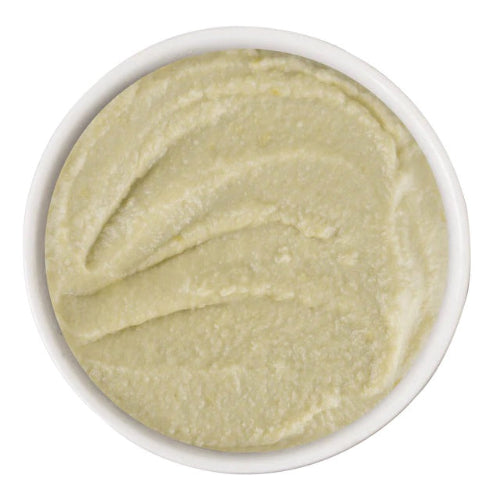 White bowl filled with a smooth, light green substance on a white background