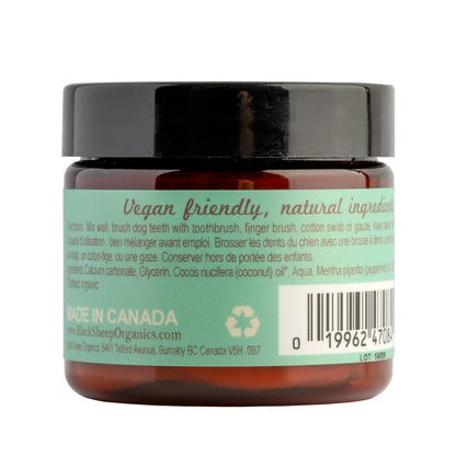 A jar of Black Sheep Organics dog grooming balm, showing the back of the amber glass jar with a black lid and a mint green label containing product details and a barcode at Harmony Pet Supplies, Scarborough. 