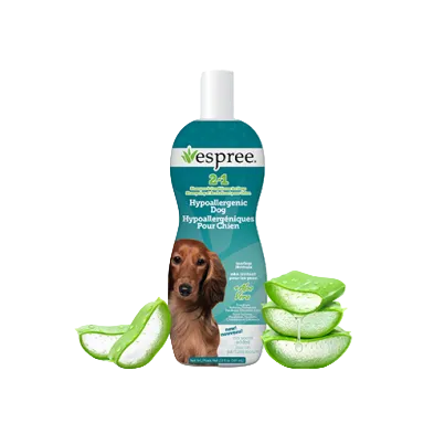 A bottle of Vespree 2-in-1 Hypoallergenic Dog Hair Cleanse shown on a white background with a dachshund on the label and aloe vera slices around the bottle at Harmony Pet Supplies, Scarborough.