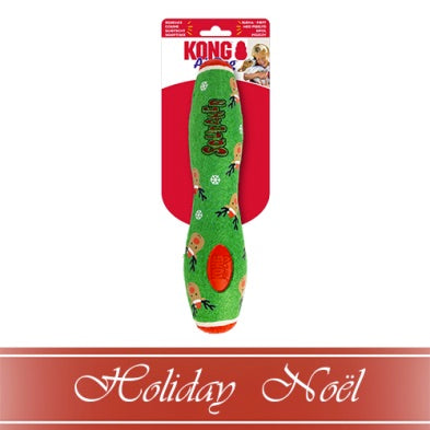 Green dog toy with festive design in packaging on a white background