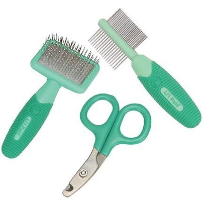 Set of green pet grooming tools including a brush, comb, and scissors on a white background.