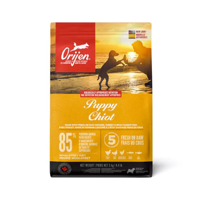 Orijen Puppy Chiot dog food package with sunset beach scene and silhouette of a child and dog. Harmony Pet Supplies, Scarborough