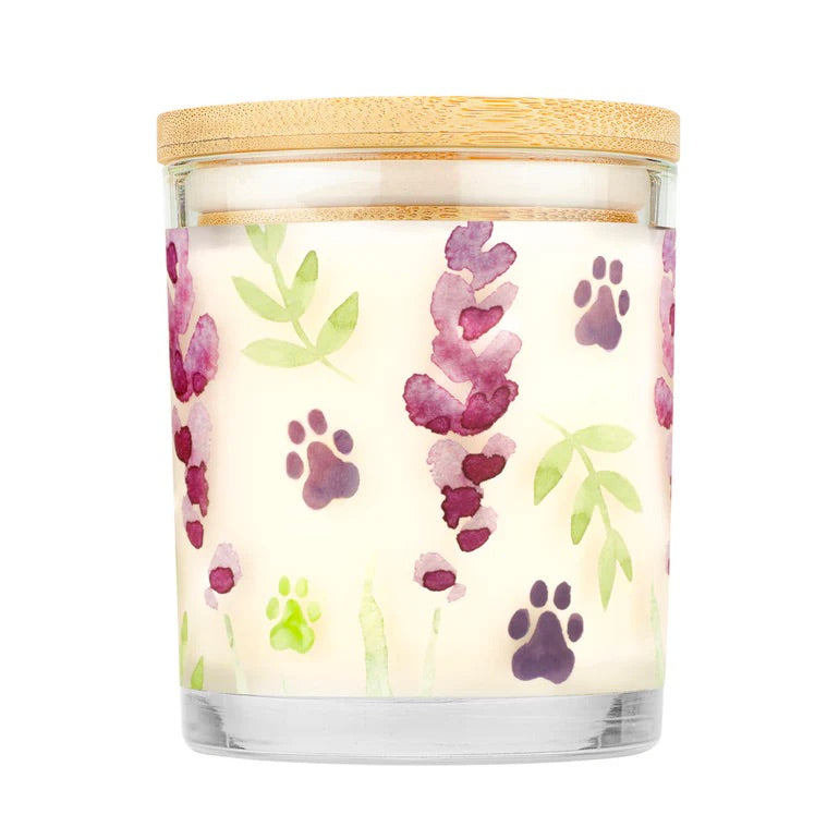 Candle with paw print and leaf pattern on a white background