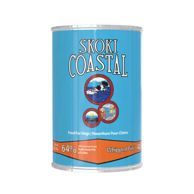 A can of Skoki Coastal dog food, specifically Whipped Pâté, on a plain white background. The can features a bright blue label with white and black lettering, circular graphics of dogs, and an orange band at the bottom at Harmony Pet Supplies, Scarborough.