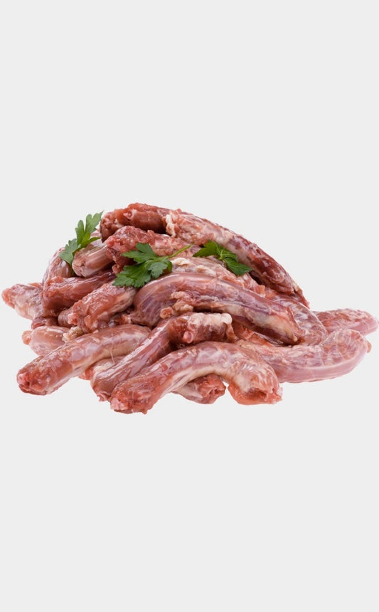Pet Raw meat of chicken necks with green herbs on a white background