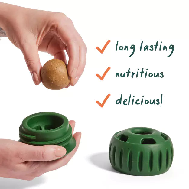 Green woof dog toy container with a small pupsicle treat, hands holding it, and text highlighting benefits on a white background at Harmony Pet Supplies, Scarborough