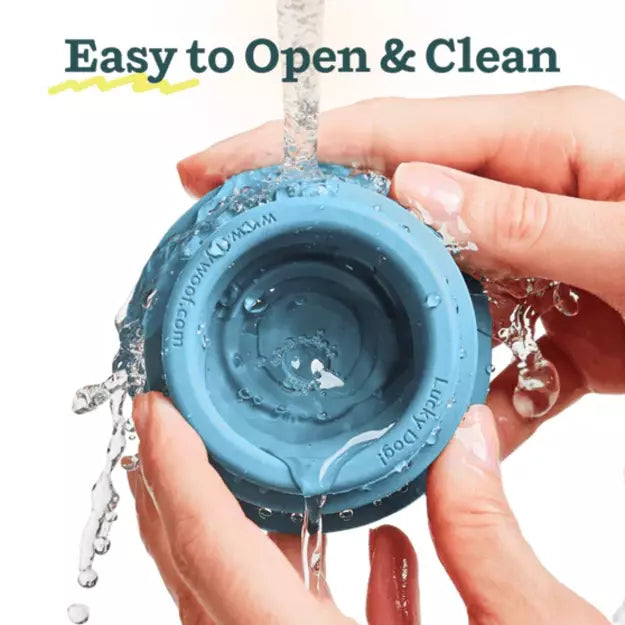 Woof Blue silicone dog toy being washed with water, text 'Easy to Open & Clean' above at Harmony Pet Supplies, Scarborough