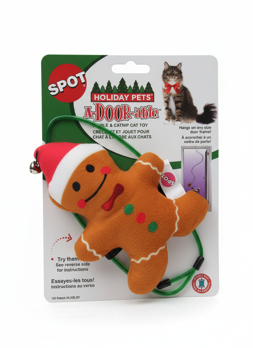 Gingerbread man-shaped dog toy on a card with branding on a wooden surface. Harmony Pet Supplies fb