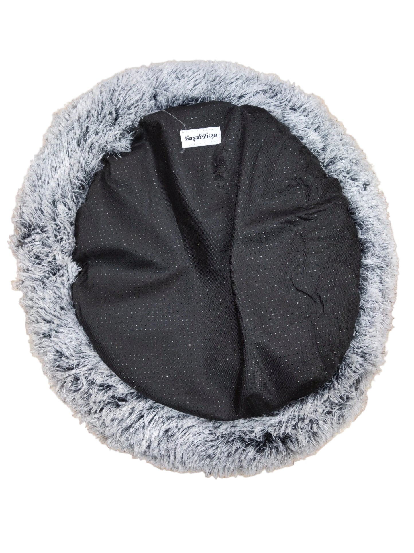 LuxurFurz Round pet bed with gray fluffy rim and black exterior base with firm grip on a wooden floor at Harmony Pet Supplies scarborough 