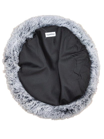 LuxurFurz Round pet bed with gray fluffy rim and black exterior base with firm grip on a wooden floor at Harmony Pet Supplies scarborough 